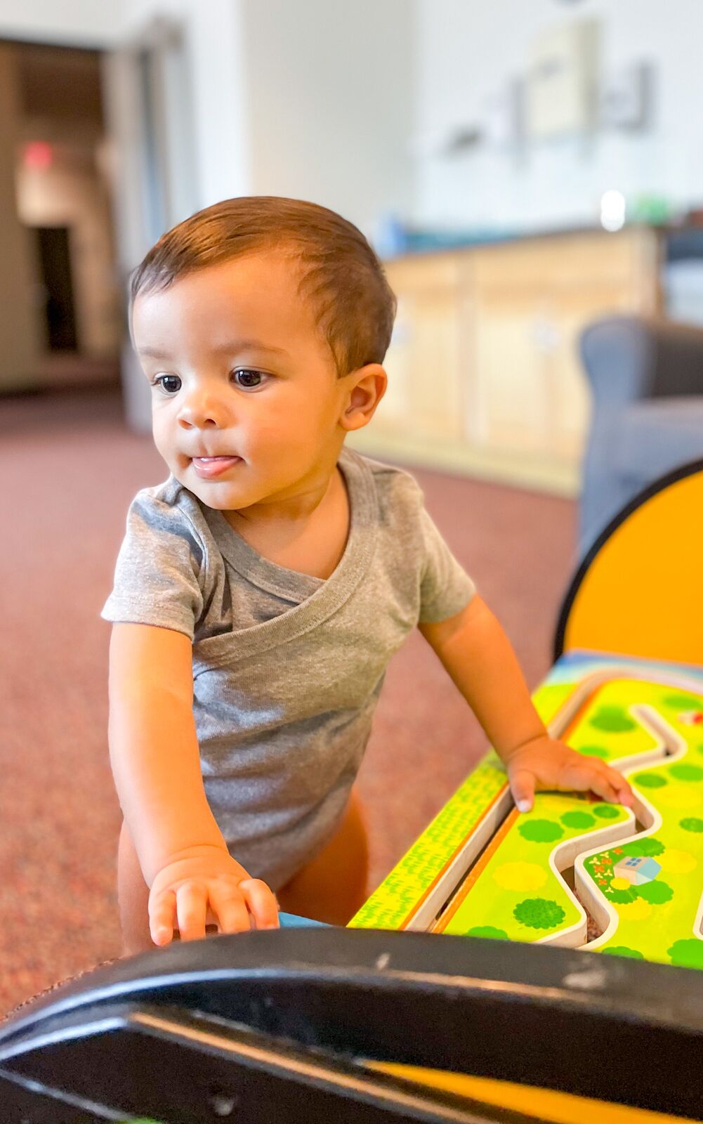 A toddler playing at an activity table