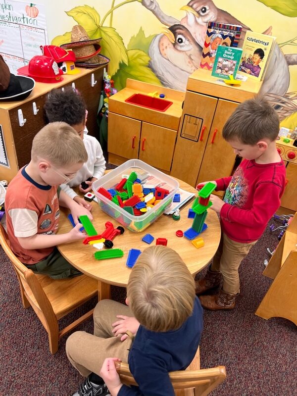 Children building with blocks around a table