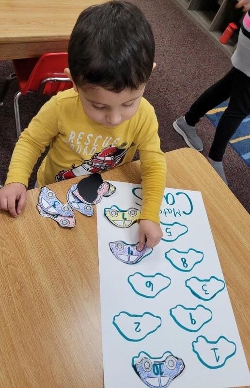 A child completing a mitten matching activity