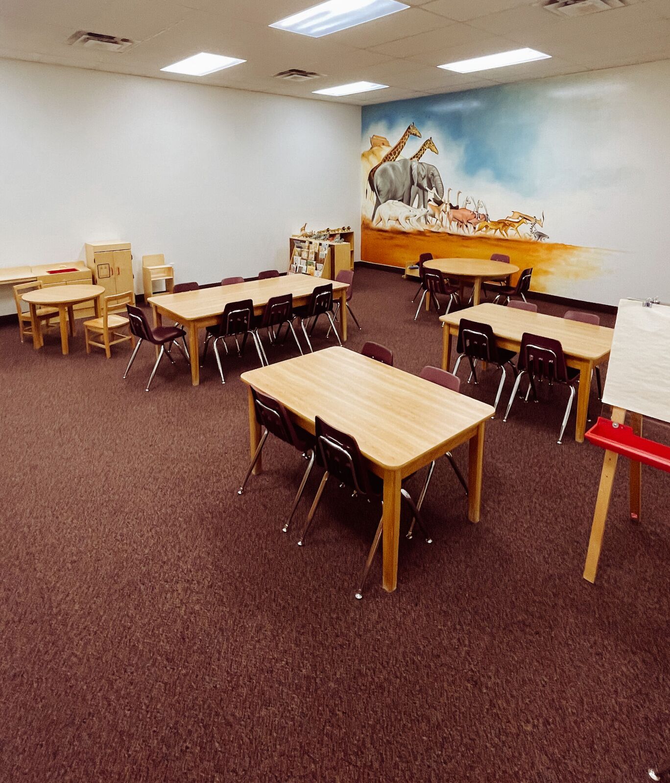 A bright preschool classroom with child-size tables