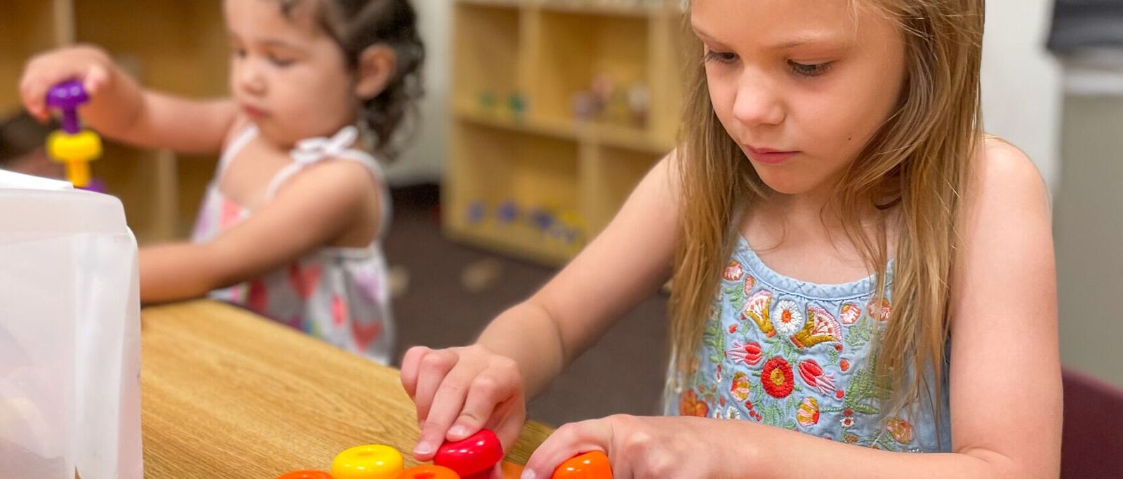 Two children playing together at a sensory table