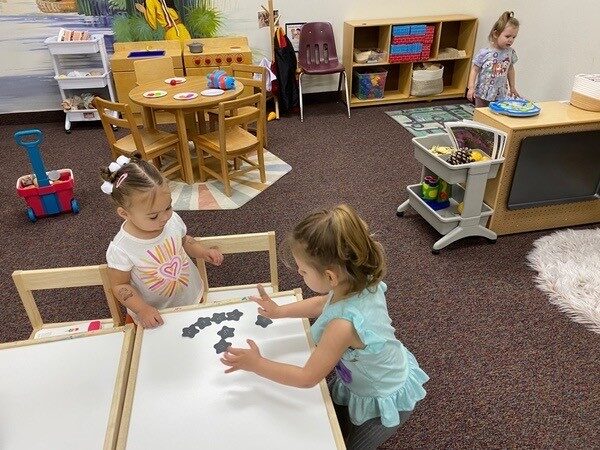 Children sorting small objects at a table